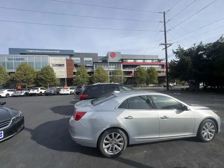 A silver sedan on the Painless Autos lot